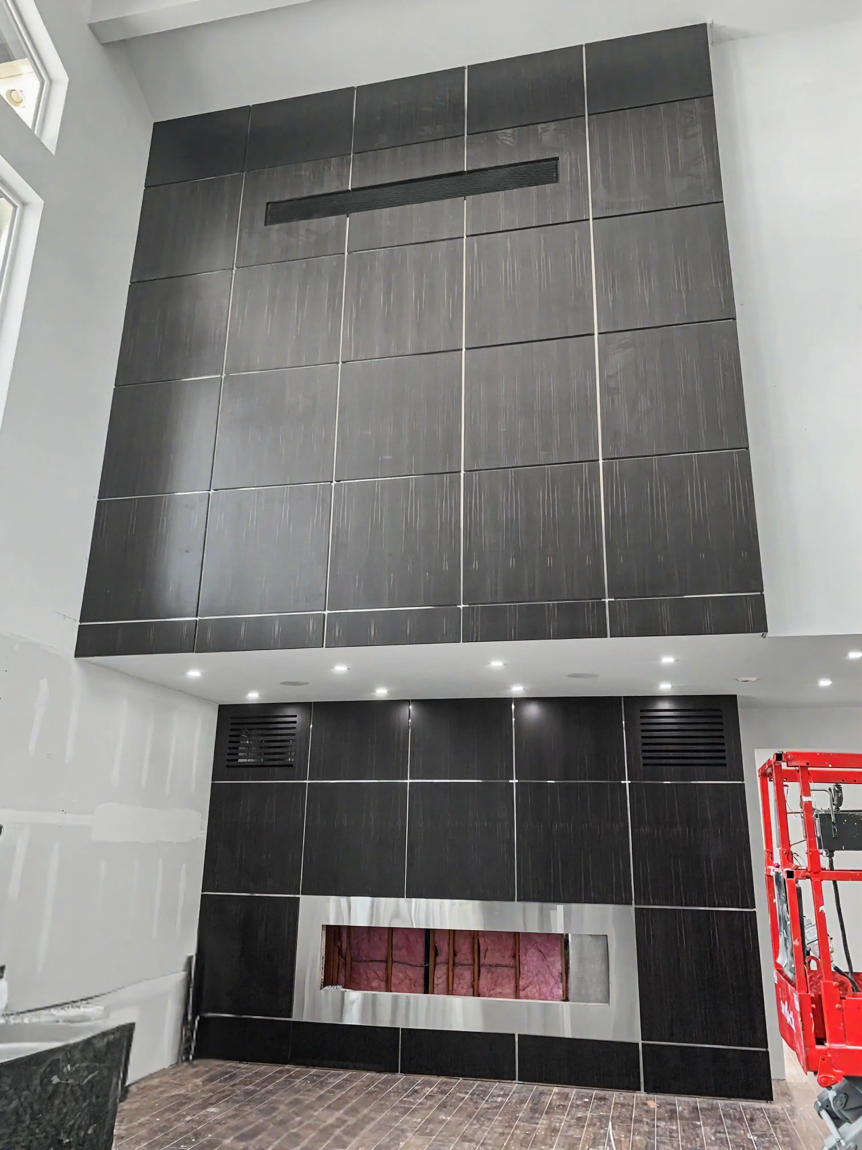 Large ebony-toned custom feature wall and fireplace design project