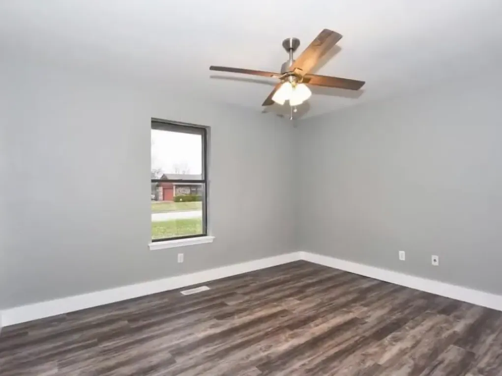 Bedroom after remodel with brighter finishes and improved continuity