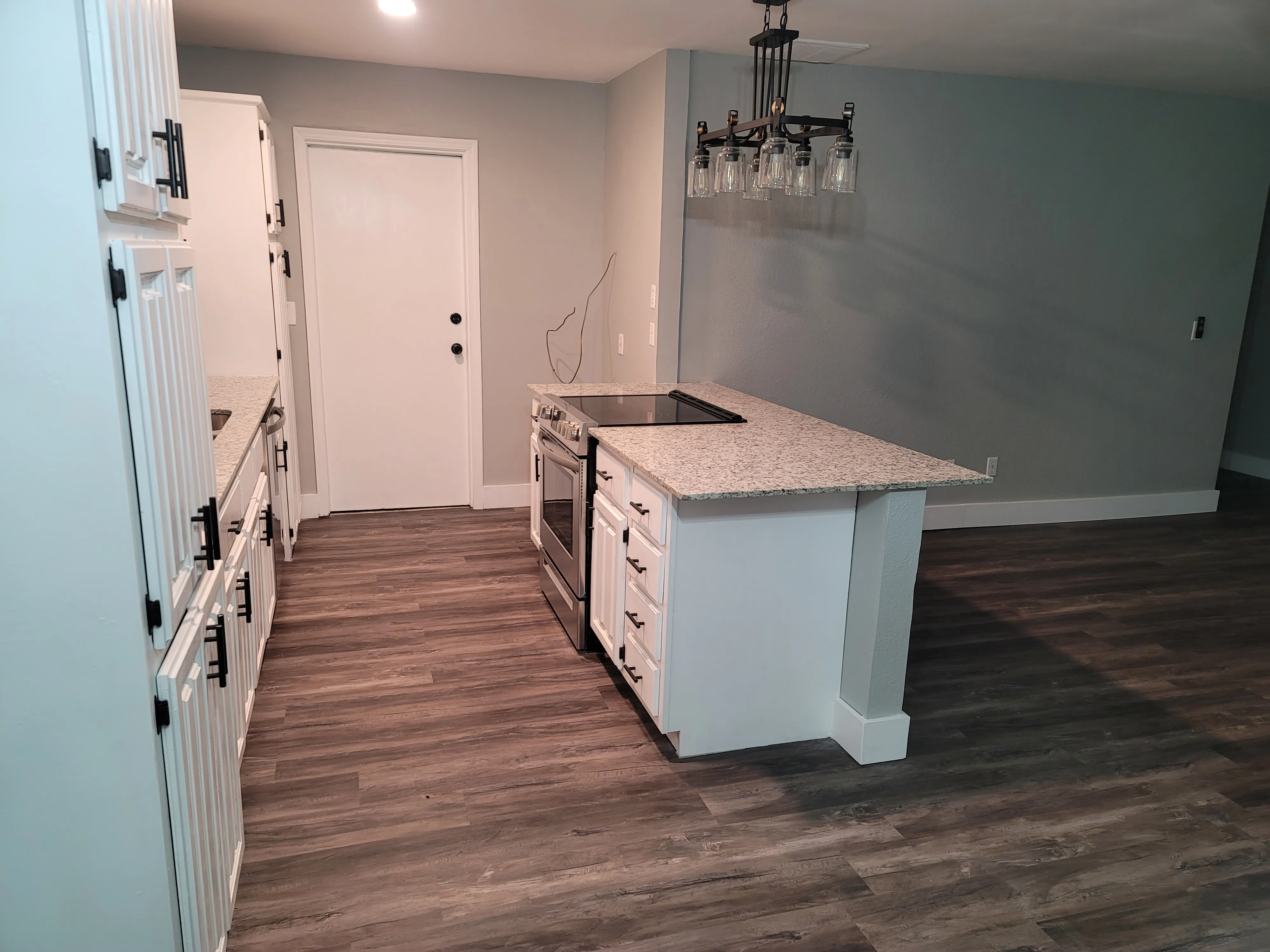 Finished kitchen view showing updated countertops and fixture alignment