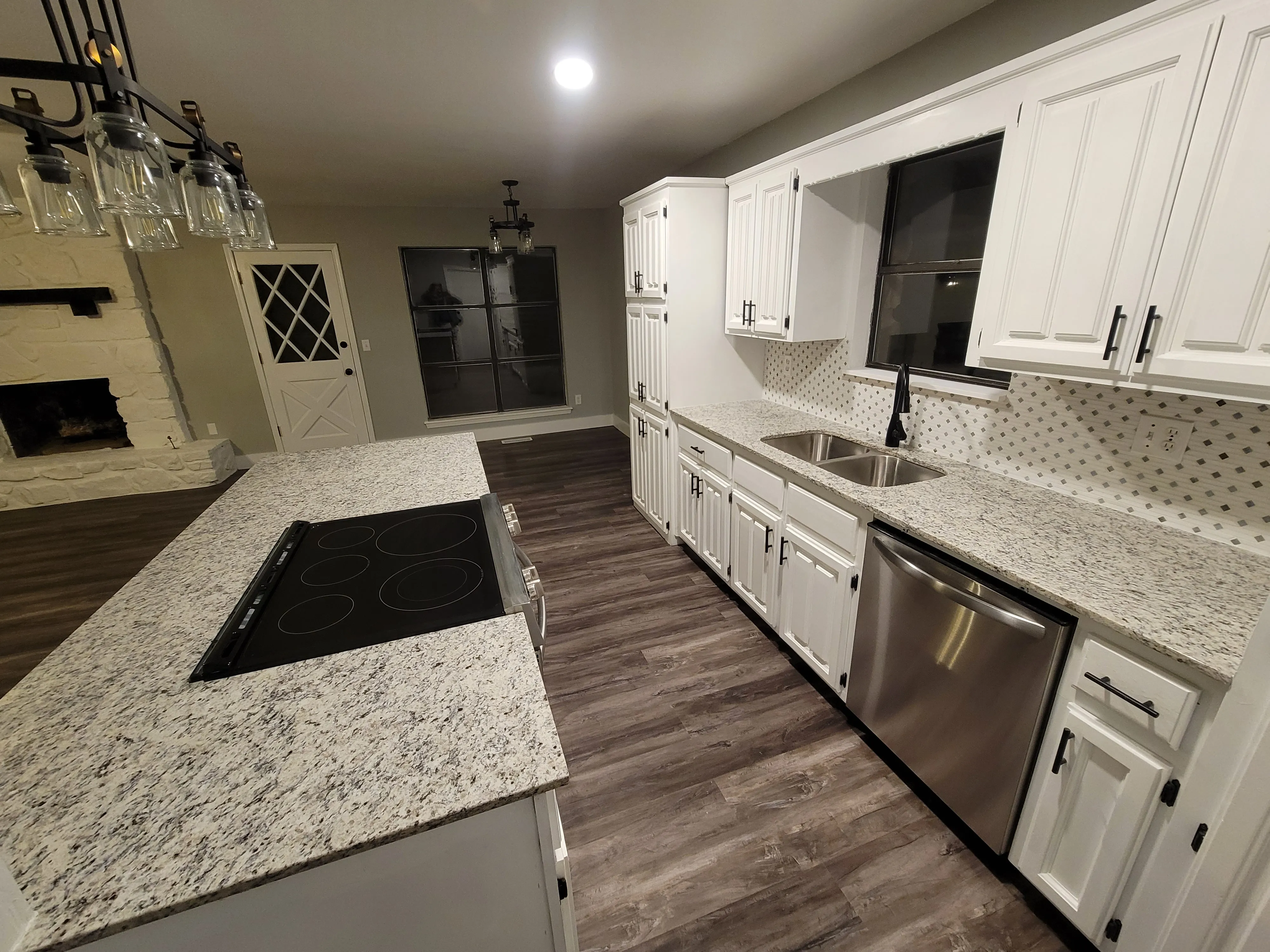 After remodel view tying kitchen and living finishes together in Tulsa